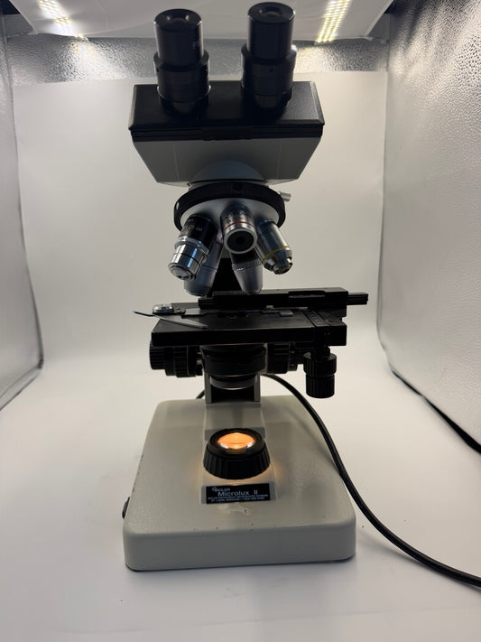 Seiler Microlux II binocular compound microscope front view with illumination working