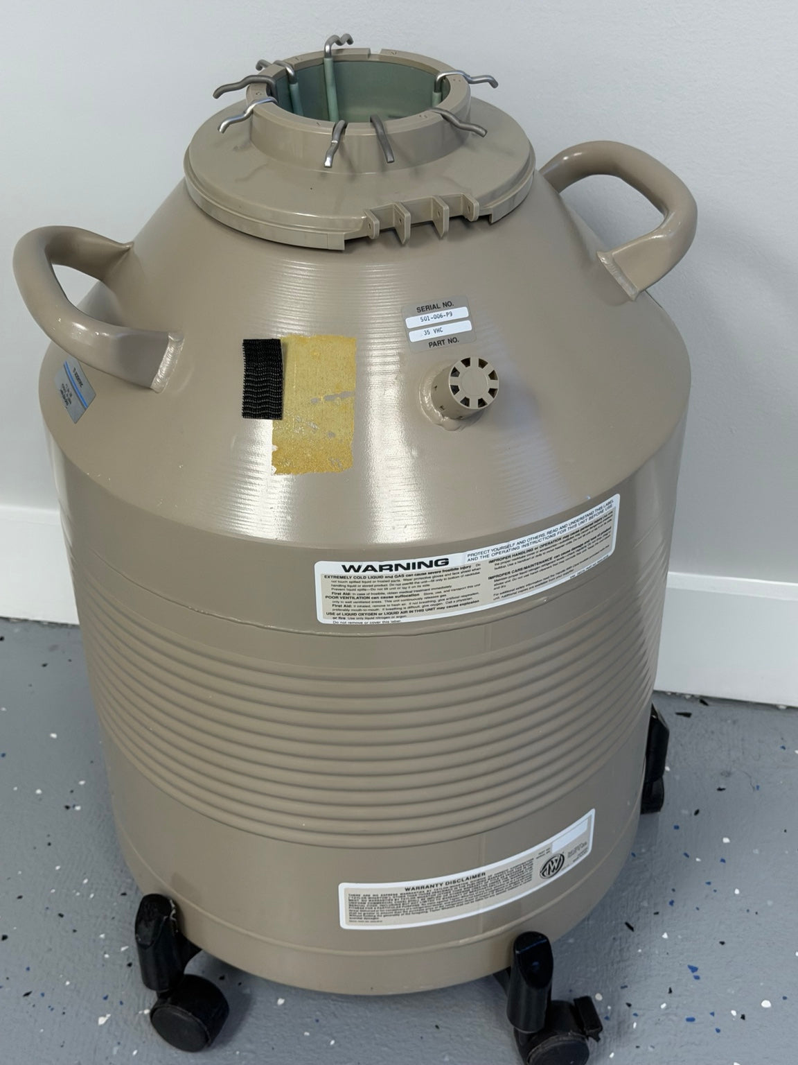 Taylor-Wharton 35VHC cryogenic dewar rear view with serial label and rolling base